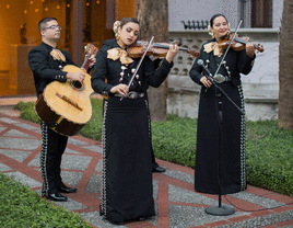 Mariachi band playing at a wedding outside. 