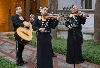 Mariachi band playing at a wedding outside. 