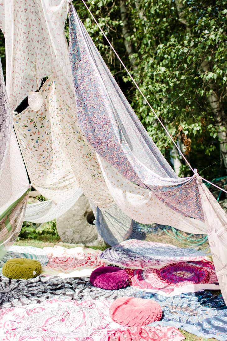 In lieu of a more traditional lounge, Nicole and Dor invited guests to kick back and relax under the shade of airy panels of floral-printed fabric, formed to create a cozy open-air tent.