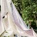In lieu of a more traditional lounge, Nicole and Dor invited guests to kick back and relax under the shade of airy panels of floral-printed fabric, formed to create a cozy open-air tent.