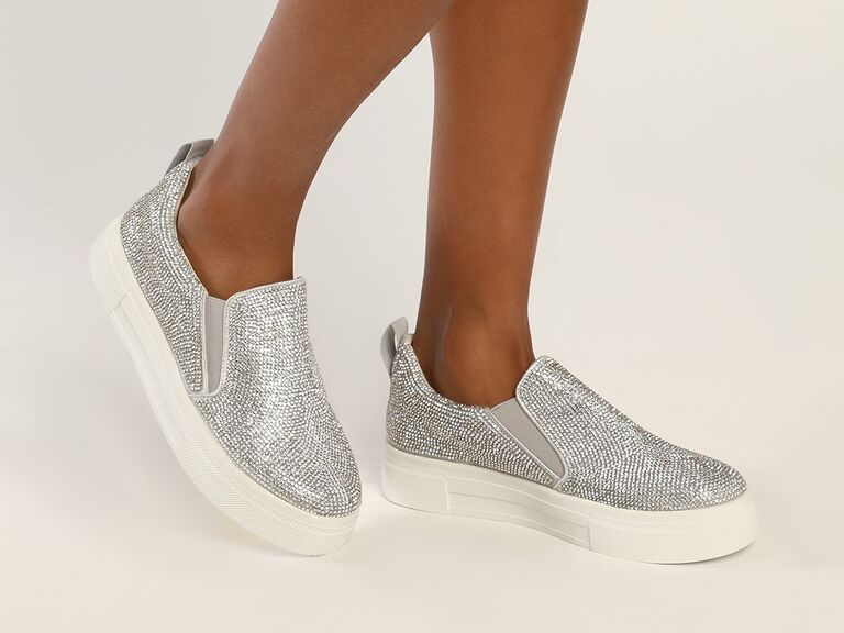Model wearing slip-on sneakers with silver rhinestones