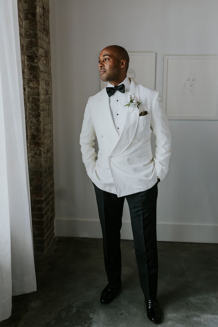 Groom in White Tuxedo Jacket and Black Pants, Bow Tie Poses in Hotel Room