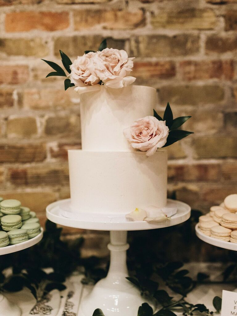 two tier white wedding cake with blush roses