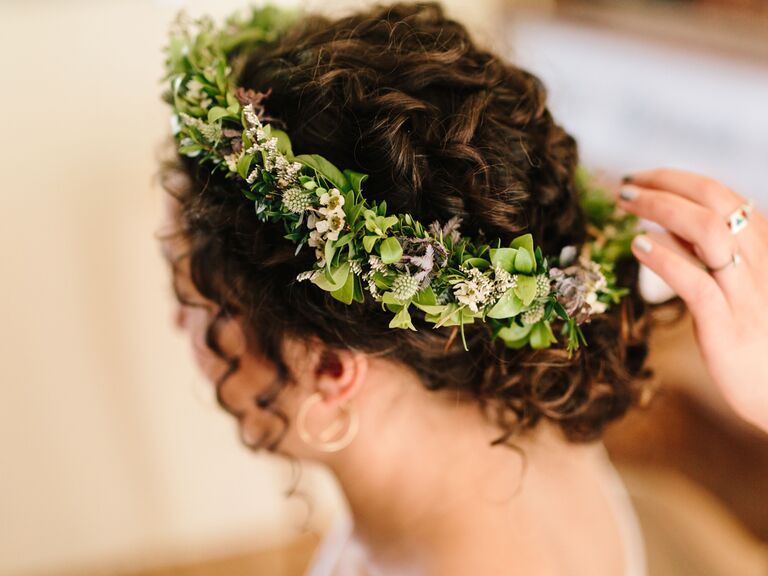 side hairstyles for wedding low curly bun with flower crown