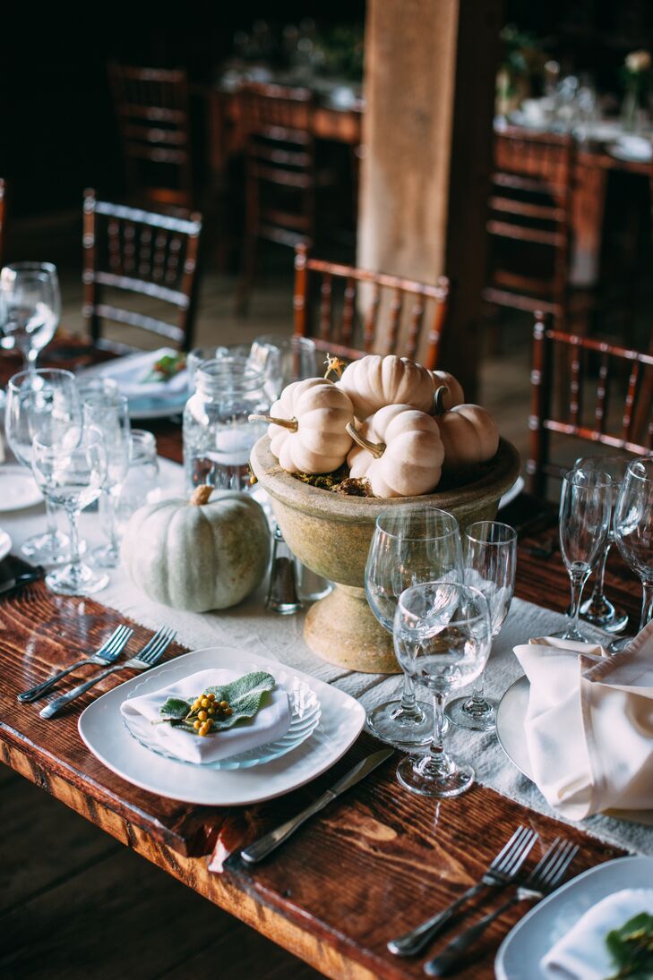 In addition to floral centerpieces, Molly and Ryan also had arrangements of cinderella pumpkins in white and pale orange. Every place seating was decorated with hypericum berries.