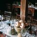 Cinderella Pumpkin Centerpieces in Earthy Pedestal Vases