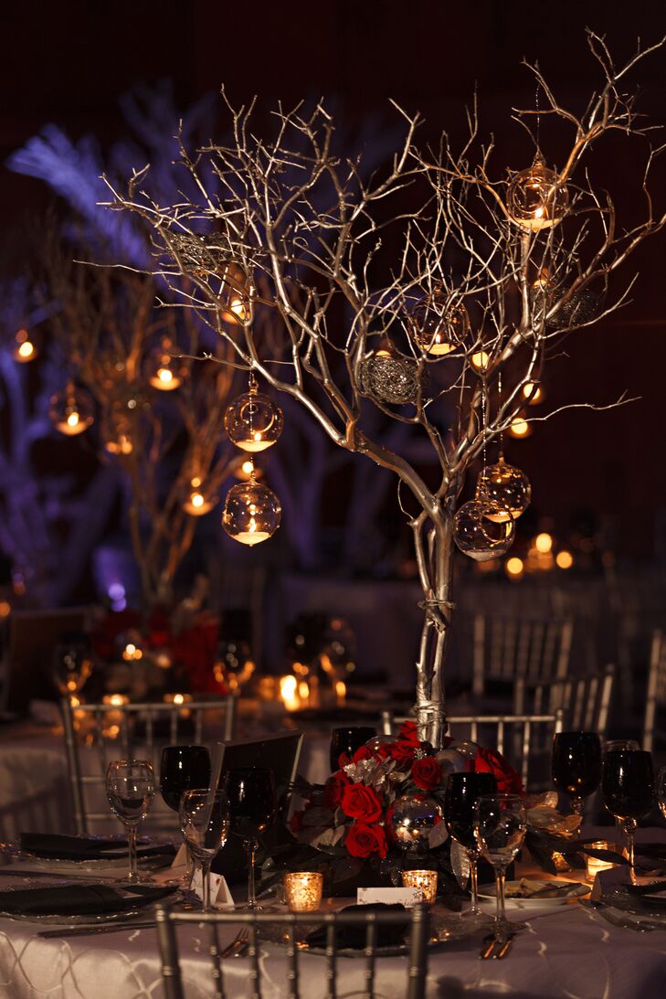 “Centerpieces consisted of a base with red roses and silver embellishments, such as leaves and berries,” says Karen. “Tall silver branched trees extended from the base and were adorned with candlelit hanging ornaments and silver birds nests.”