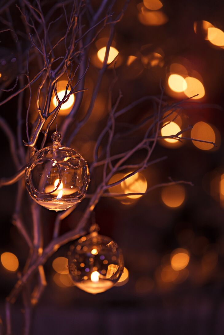 Glass ornaments decorated the tree branch centerpiece, and each were lit with a candle on the inside.