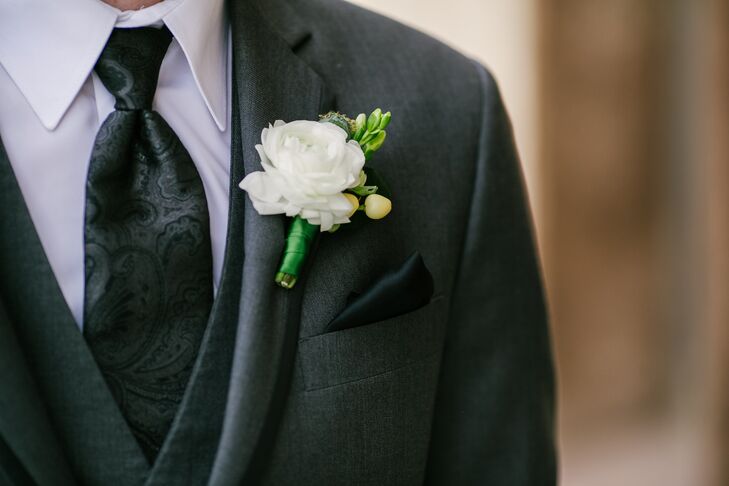 Groomsmen wore traditional black suits accented with a clean, simple white rose boutonniere.