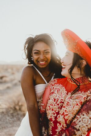 Bride in Red Vietnamese Ao Dai Sharing Embrace With Bride in White Wedding Dress