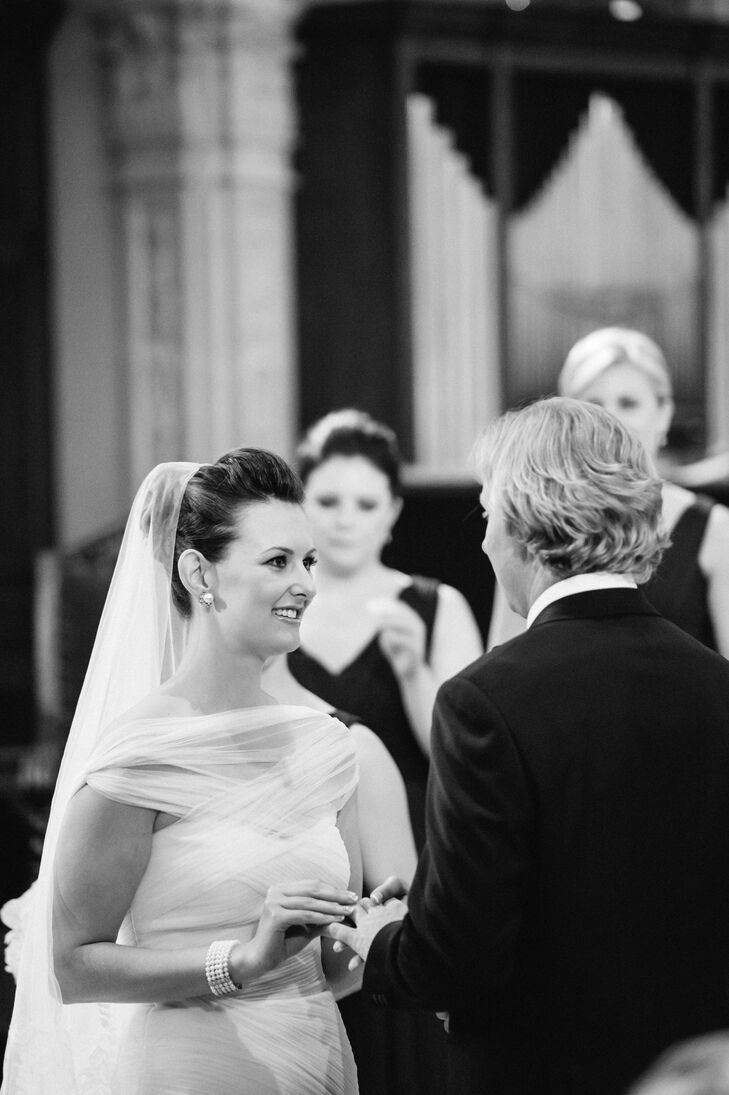 Leslie wanted something more conservative than a strapless dress for her Catholic ceremony and found the perfect balance with her modest-yet-modern Monique Lhuillier gown.  It offered that traditional aspect, but had a unique twist, describes Leslie.  It had the traditional mermaid shape but I tweaked the dress adding a shear fabric piece similar to a very fine mesh to the chest to get away from the strapless look.