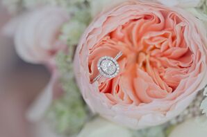 Oval Diamond Wedding Ring Resting on Pink Peony