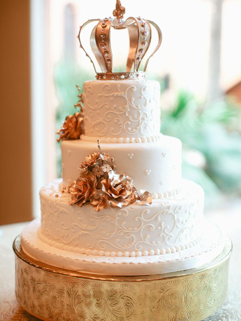Crown cake topper on fairytale-themed wedding cake