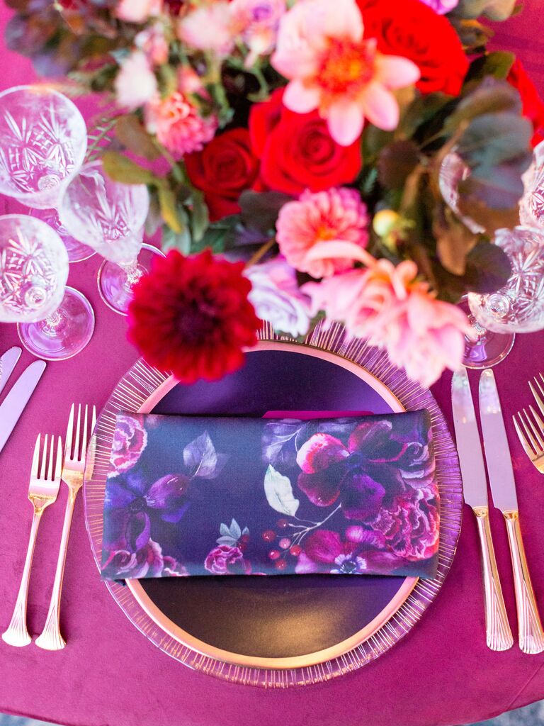 wedding place setting with viva magenta linens and floral print napkin