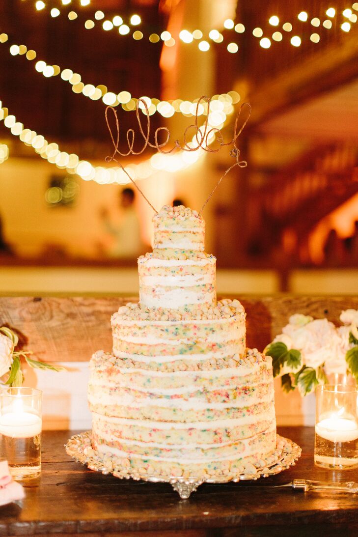 Lexi and Jeff enjoyed a four-tiered naked funfetti cake for their wedding. They loved the birthday-cake look and the bronze-wire “We do” cake topper. The cake perfectly complemented the rustic barn venue while still adding their own twist on tradition.