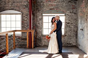 Groom Embracing Bride in Loft