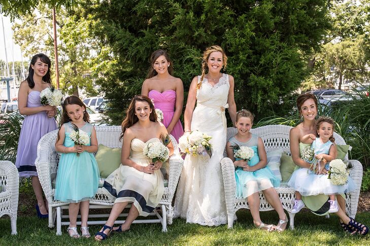 "My bridesmaids were all my younger sisters, so I wanted them to look their ages," Meagan says. "I decided to let them each wear a different color." Their W Too dresses featured bold navy stripes at the bottom of the skirt to tie in with the nautical theme. Meagan's flower girls wore aqua blue dresses.