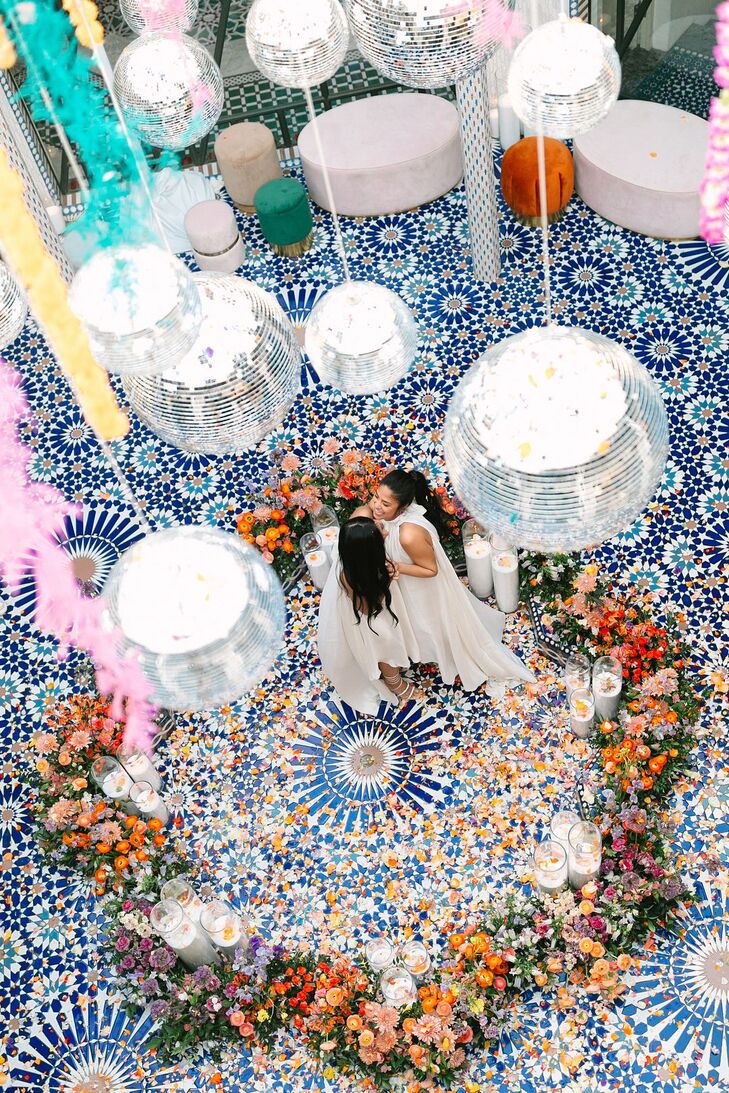 Couple Dancing on Tiled Dance Floor Under Disco Balls