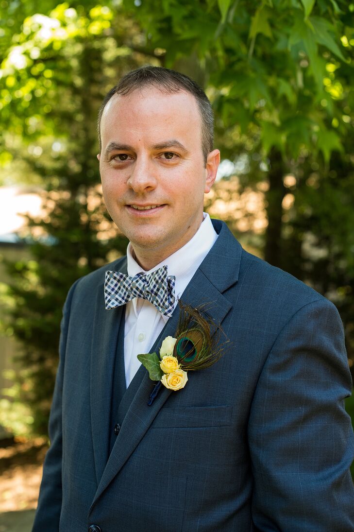 Rich wore a three-piece navy suit with a checkered bow tie. His boutonniere included yellow roses and a peacock feather for some pizzaz. rn