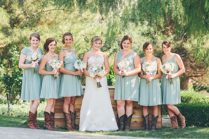 Mismatched dusty shale bridesmaids dresses by J Crew mixed with cowboy boots created a fun, casual look for Madison's bridesmaids.