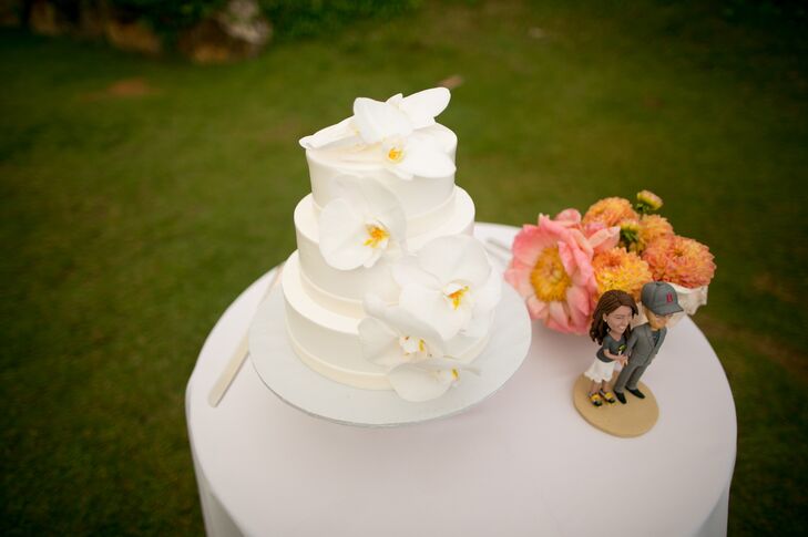 The three-tiered ivory wedding cake was simply decorated with elegant orchid flowers.