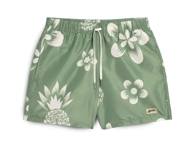 green swim shorts with floral and pineapple prints