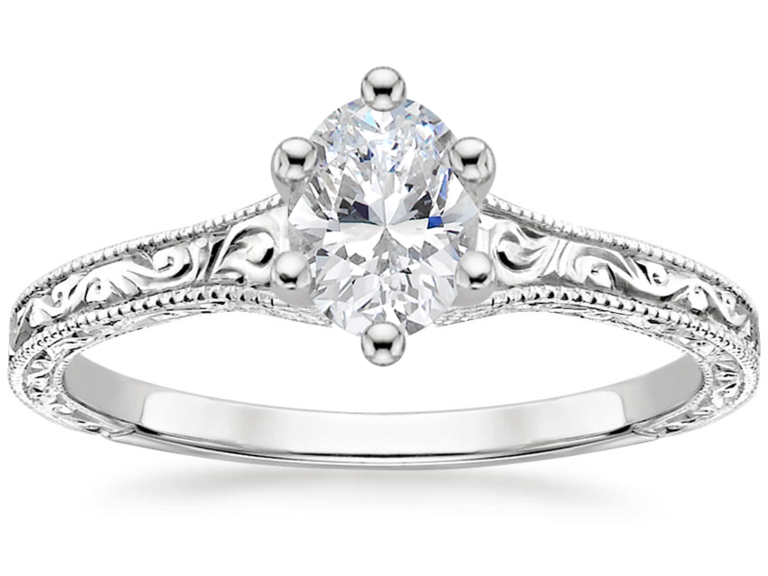 Oval center diamond with white gold engraved band