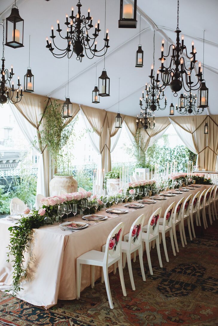 A small guest list enabled Whitney and Ryan to seat all their friends and family members around a single long table, creating the feel of an intimate family dinner. Hanging overhead were dozens of carriage lanterns and intricate candelabras that lent a note of whimsy and extravagance to the setting as the sun began to set over the city skyline.