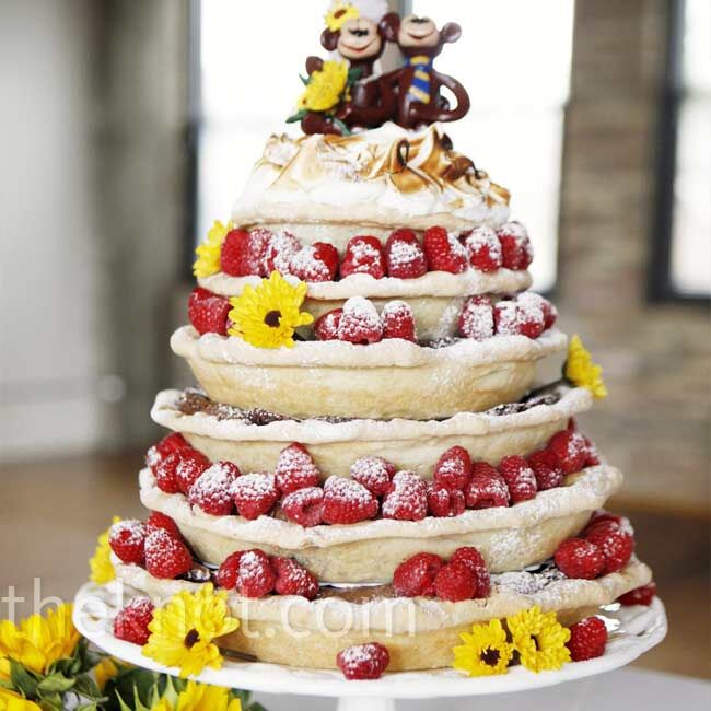 Robyn hates cake, so she and Jordan had a wedding pie. The cartoon-like monkey toppers were personalized with sunflowers and a blue-and-yellow-striped tie, like the one Jordan wore.