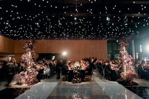 Wedding Guests Eating Dinner Under Moody Twinkle Lights