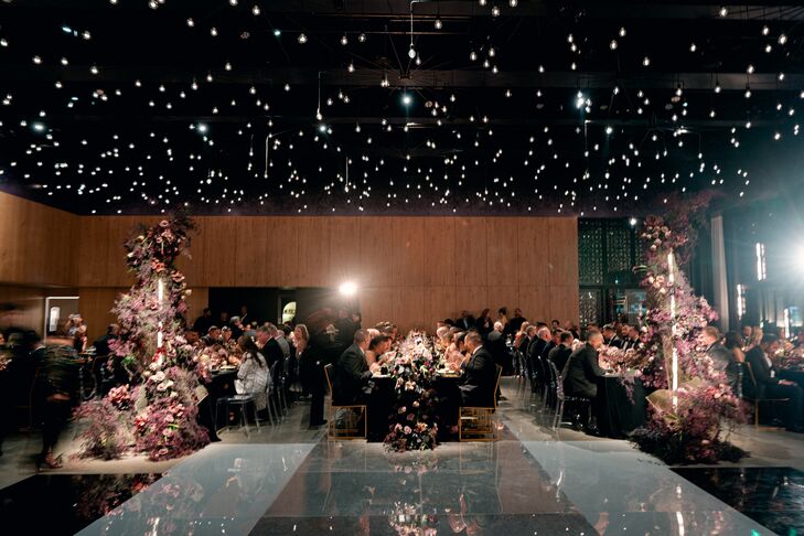 Wedding Guests Eating Dinner Under Moody Twinkle Lights