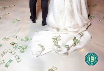 couple with money trailing after the wedding