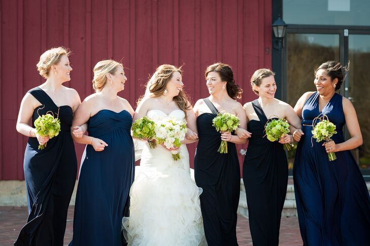 Since two of her bridesmaids were pregnant, Shannon let her bridesmaids choose their own gown, requesting only that they be long and in a shade of navy blue. Three of the women donned matching one-shoulder gowns with empire waist silhouettes, while the remaining two went with a strapless empire-style gown and a classic A-line style with a V-shaped neckline.