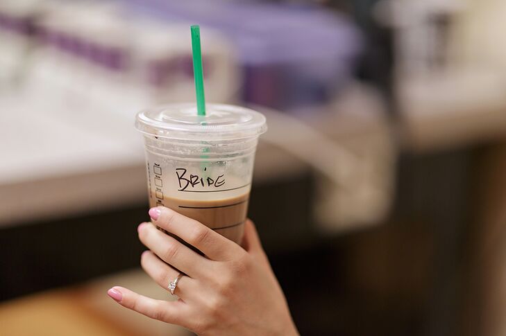 Erin's wedding ring was a simple, princess cut diamond. She had a pink manicure on the day of her wedding. She also got a coffee from Starbucks for her wedding jitters, labeled "Bride."