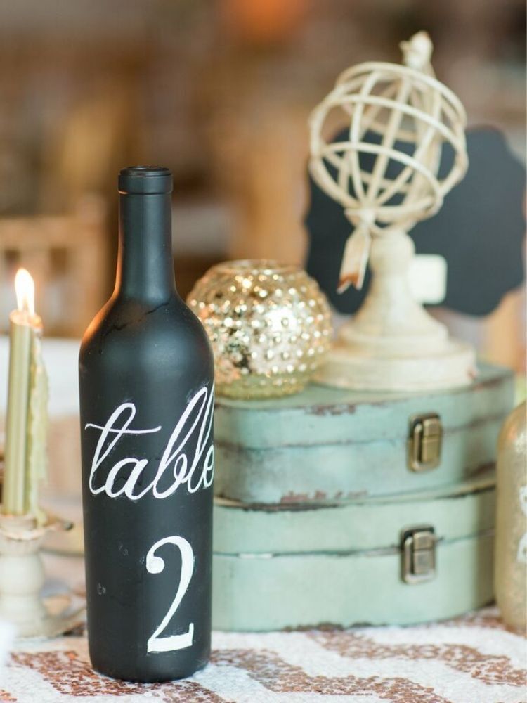 centerpiece with wine bottle and vintage suitcases