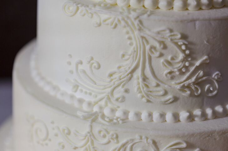 The three tier wedding cake was baked and decorated by Erin. The flavor was yellow cake with a lemon curd filling and buttercream frosting.