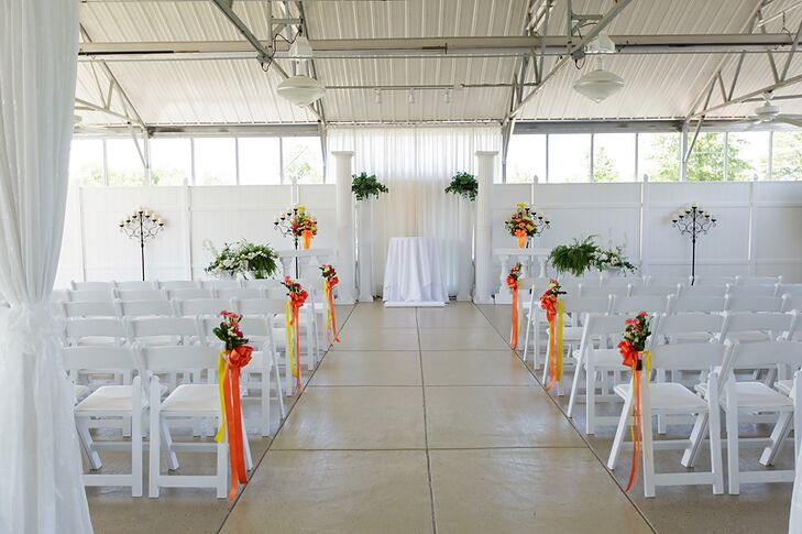 The ceremony venue was a glass atrium with white walls. Heather and Joey decorated the venue with orange ribbons and green bouquets that popped against the white background.