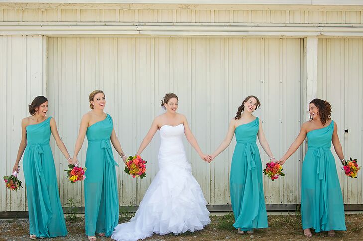 The bridesmaids wore one-shoulder, turquoise dresses by Jim Hjelm.