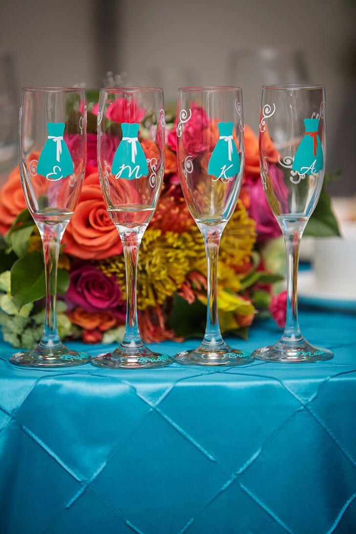 Heather gave her bridesmaids customized champagne flutes with turquoise dresses and their monograms printed on them.