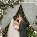 Romantic First Kiss with Greenery, Roses and Draping