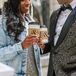 Bride and Groom Holding Coffee Cups With Custom Coffee Cup Sleeves