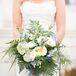 Since Lauren has always had a soft-spot for blue hydrangea, that became the starting point for her romantic bouquet. Her florist added white anemones, plumosa ferns and large rose blooms and found a pale blue velvet ribbon to wrap the stems.