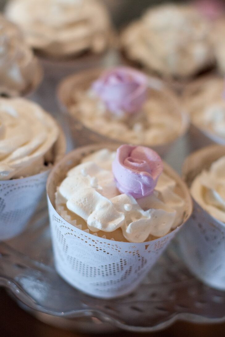 In place of traditional wedding cake, the couple served their guests cupcakes topped with small pink garden roses.