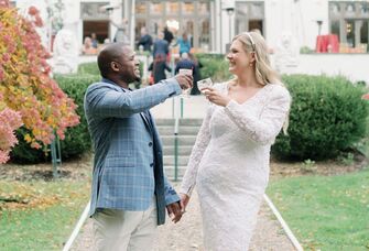 A bride and groom toast themselves on their wedding day