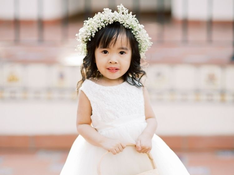 A wedding flower girl with a baby's breath flower crown