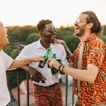 A groom celebrates with two of his best friends.