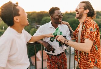 A groom celebrates with two of his best friends.