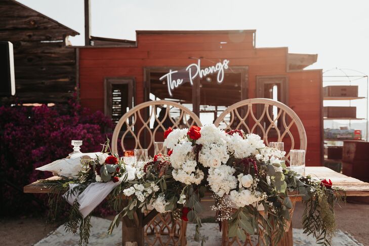 Bohemian Sweetheart Table with Chairs and Flower Arrangement