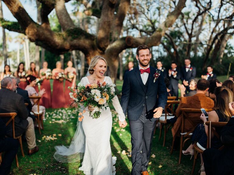 Bride and groom walking down the aisle after wedding ceremony.