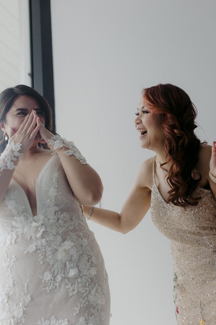 Bride in Fitted Gown With Floral Appliques, Illusion Sleeves Laughing With Mom